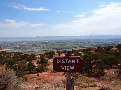 [In the foreground is the sign, Distant View, which accurately describes what is seen beyond it as the sun lights the earth view for miles.]